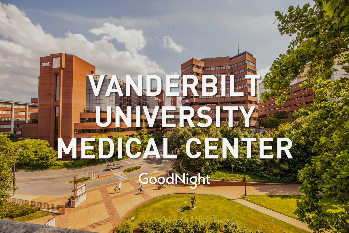 This image showcases the exterior of Vanderbilt University Medical Center, featuring landscaped green areas and pathways leading to the entrance. The scene conveys accessibility, professional care, and a welcoming atmosphere, emphasizing the proximity to crucial medical facilities.